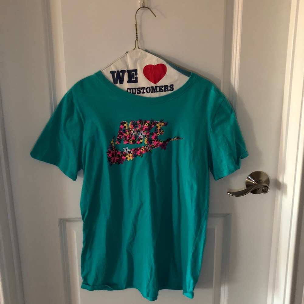 Teal short sleeve tee shirt that says “Nike”